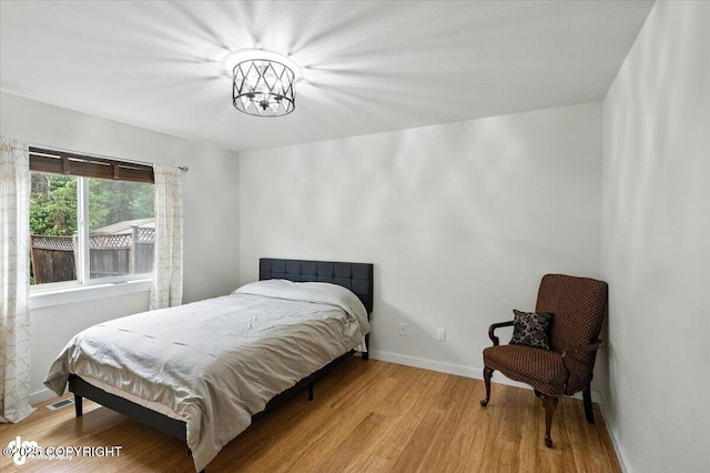8968 Little Brook St, Anchorage, AK 99507 - bedroom with light wood-style floors and a chandelier