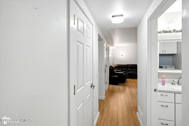 8968 Little Brook St, Anchorage, AK 99507 - hall featuring a sink and light wood finished floors