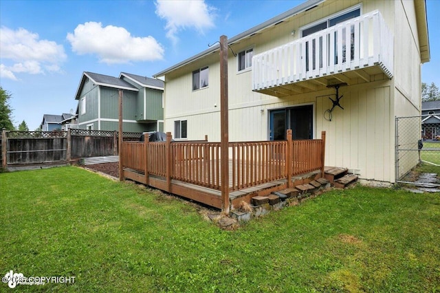 8968 Little Brook St, Anchorage, AK 99507 - back of property with a fenced backyard, a deck, and a balcony