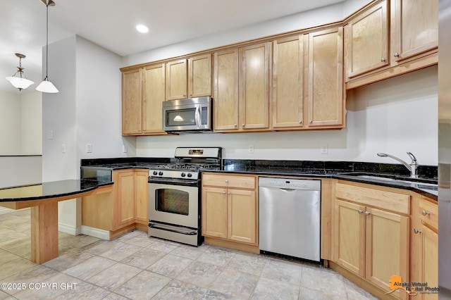 6942 Meadow St # 2-305, Anchorage, AK 99507 - kitchen featuring appliances with stainless steel finishes, a sink, a peninsula, recessed lighting, and hanging light fixtures