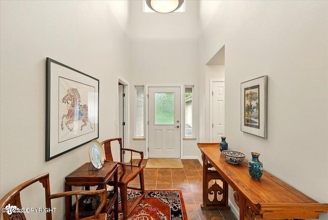 48585 Runners Ave, Soldotna, AK 99669 - entryway featuring stone tile flooring, a high ceiling, and baseboards