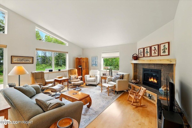 48585 Runners Ave, Soldotna, AK 99669 - living area with wood finished floors, a tiled fireplace, and high vaulted ceiling