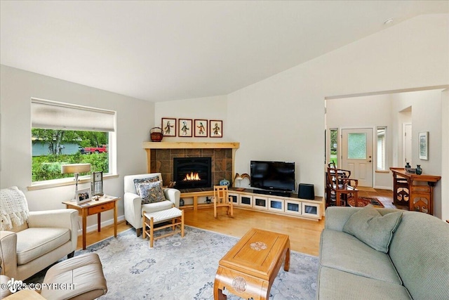 48585 Runners Ave, Soldotna, AK 99669 - living room featuring lofted ceiling, wood finished floors, and a tile fireplace