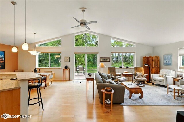 48585 Runners Ave, Soldotna, AK 99669 - living room with light wood finished floors, plenty of natural light, vaulted ceiling, and ceiling fan