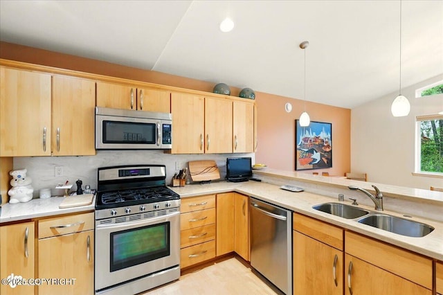 48585 Runners Ave, Soldotna, AK 99669 - kitchen featuring stainless steel appliances, light brown cabinets, a sink, pendant lighting, and tasteful backsplash