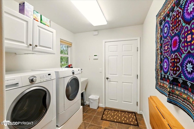48585 Runners Ave, Soldotna, AK 99669 - laundry area with washer and clothes dryer, dark tile patterned flooring, baseboards, and cabinet space