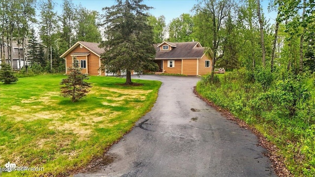 48585 Runners Ave, Soldotna, AK 99669 - rustic home featuring a front lawn and asphalt driveway