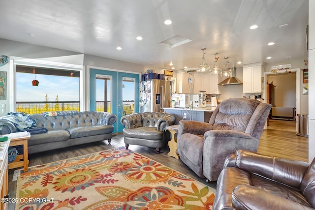 9291 Basher Dr, Anchorage, AK 99507 - living room with wood finished floors, recessed lighting, and french doors