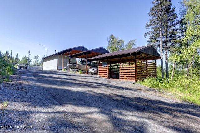 9291 Basher Dr, Anchorage, AK 99507 - view of side of property with metal roof, an outbuilding, and gravel driveway