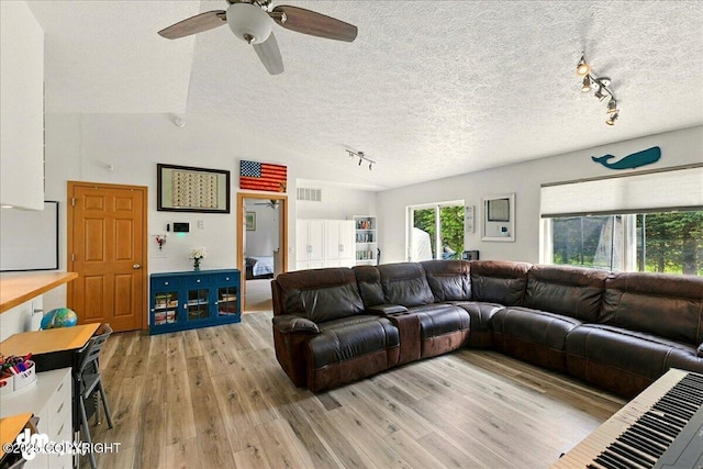 1213 Channel Way, Kenai, AK 99611 - living room featuring track lighting, a textured ceiling, light wood-style floors, a ceiling fan, and lofted ceiling