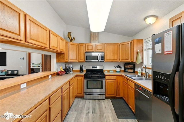 1213 Channel Way, Kenai, AK 99611 - kitchen featuring stainless steel appliances, vaulted ceiling, light countertops, and light wood finished floors