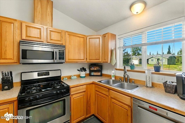 1213 Channel Way, Kenai, AK 99611 - kitchen featuring appliances with stainless steel finishes, vaulted ceiling, and light countertops