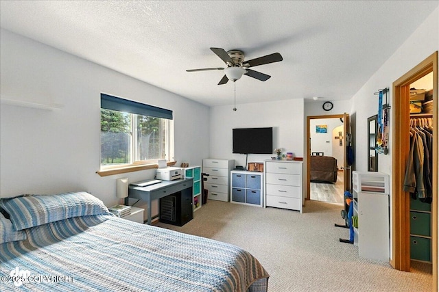 1213 Channel Way, Kenai, AK 99611 - bedroom with carpet, a textured ceiling, a ceiling fan, a walk in closet, and a closet