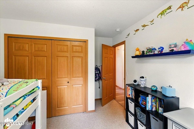 1213 Channel Way, Kenai, AK 99611 - bedroom featuring light carpet, a closet, and a textured ceiling