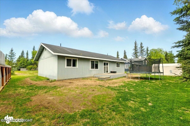 1213 Channel Way, Kenai, AK 99611 - back of property with a trampoline and a lawn