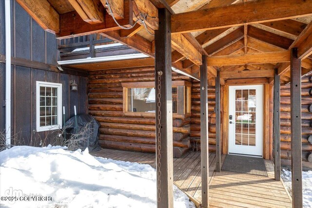 40327 S Malaspina Loop, Talkeetna, AK 99676 - snow covered property entrance with log siding and a deck