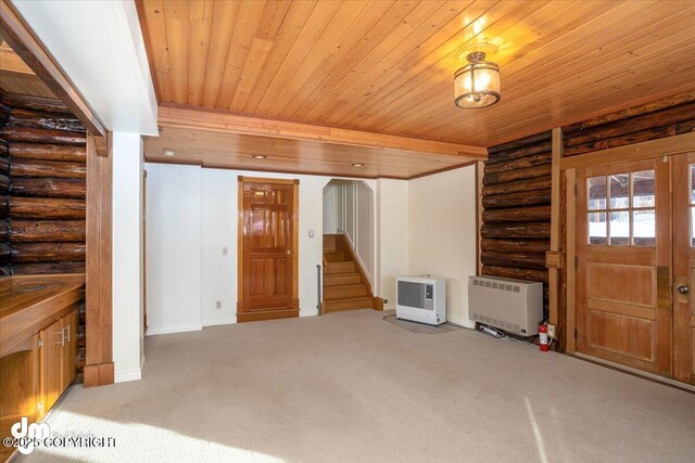 40327 S Malaspina Loop, Talkeetna, AK 99676 - unfurnished living room featuring log walls, wooden ceiling, stairway, carpet floors, and baseboards