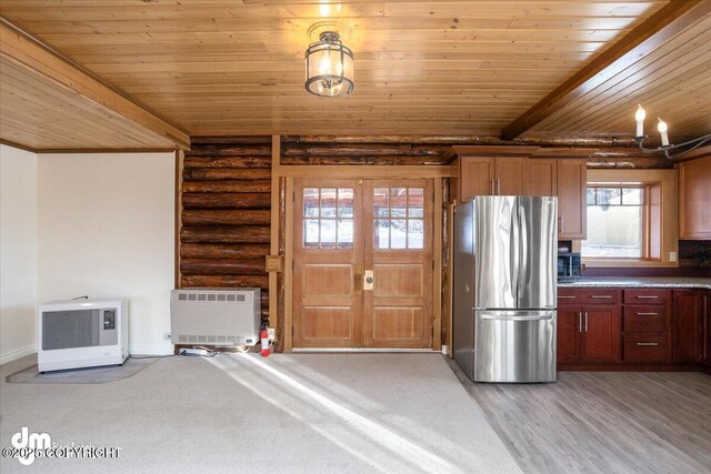 40327 S Malaspina Loop, Talkeetna, AK 99676 - kitchen featuring freestanding refrigerator, wooden ceiling, rustic walls, heating unit, and baseboards