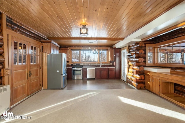 40327 S Malaspina Loop, Talkeetna, AK 99676 - kitchen with appliances with stainless steel finishes, wooden ceiling, light carpet, rustic walls, and brown cabinetry