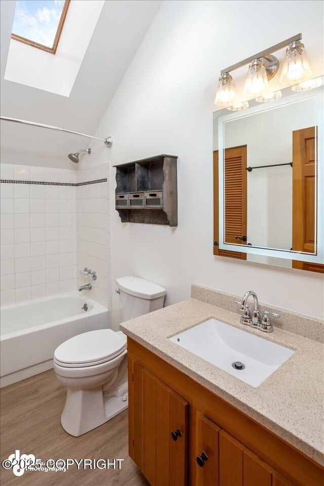 40327 S Malaspina Loop, Talkeetna, AK 99676 - bathroom featuring vanity, a skylight, toilet,  shower combination, and wood finished floors