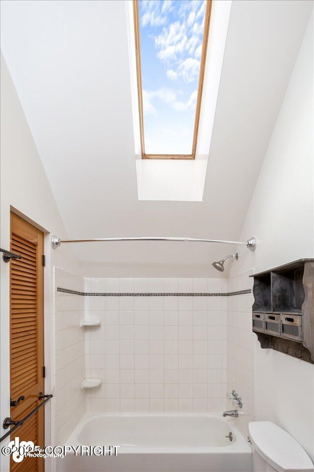 40327 S Malaspina Loop, Talkeetna, AK 99676 - full bathroom with bathtub / shower combination, vaulted ceiling, toilet, and a skylight
