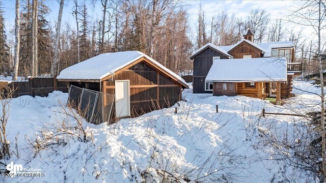 40327 S Malaspina Loop, Talkeetna, AK 99676 - snow covered back of property featuring a chimney and an outbuilding