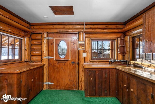 40327 S Malaspina Loop, Talkeetna, AK 99676 - foyer featuring log walls, plenty of natural light, and carpet flooring