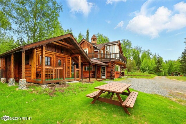 40327 S Malaspina Loop, Talkeetna, AK 99676 - rear view of property with log exterior, a yard, board and batten siding, and a wooden deck