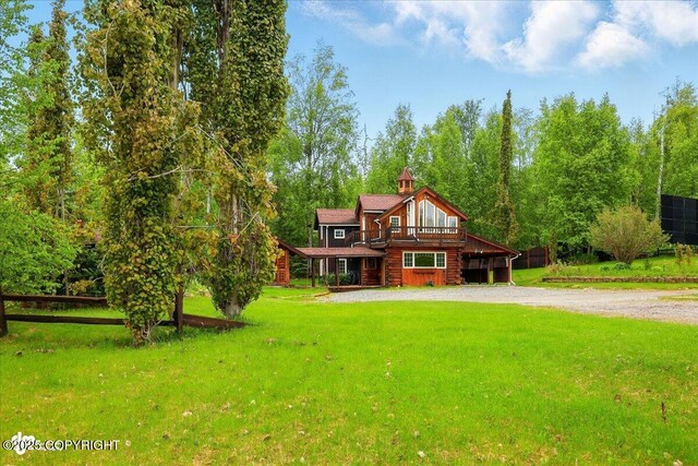 40327 S Malaspina Loop, Talkeetna, AK 99676 - rear view of house with driveway, a lawn, and a deck