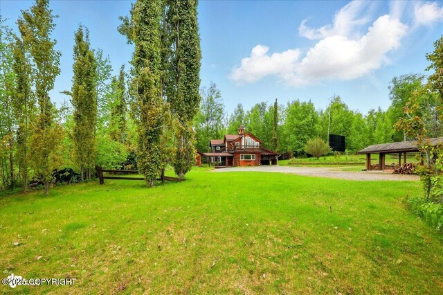 40327 S Malaspina Loop, Talkeetna, AK 99676 - view of grassy yard featuring a gazebo, driveway, and a view of trees