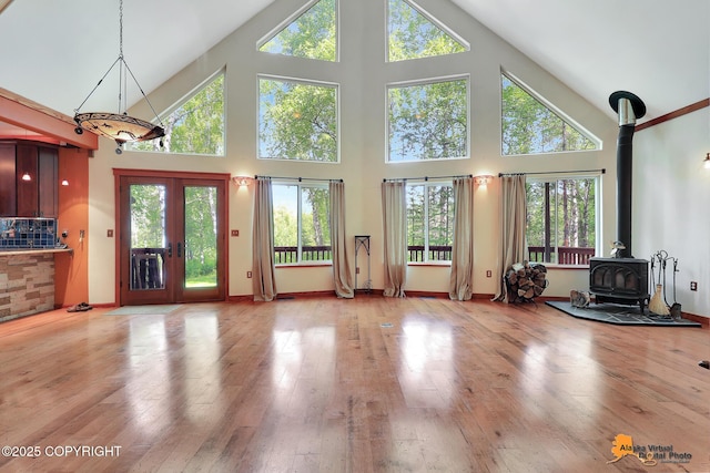 7408 N Grouse Loop, Wasilla, AK 99654 - living room with a wood stove, high vaulted ceiling, and hardwood / wood-style flooring