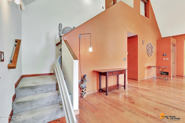 7408 N Grouse Loop, Wasilla, AK 99654 - staircase featuring a high ceiling and wood finished floors
