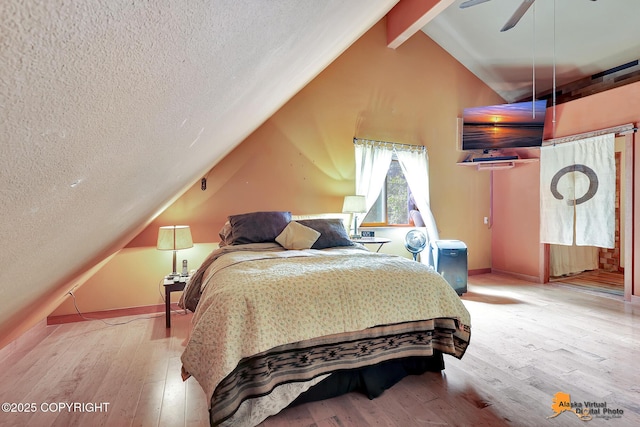 7408 N Grouse Loop, Wasilla, AK 99654 - bedroom with a textured ceiling, wood finished floors, and ceiling fan