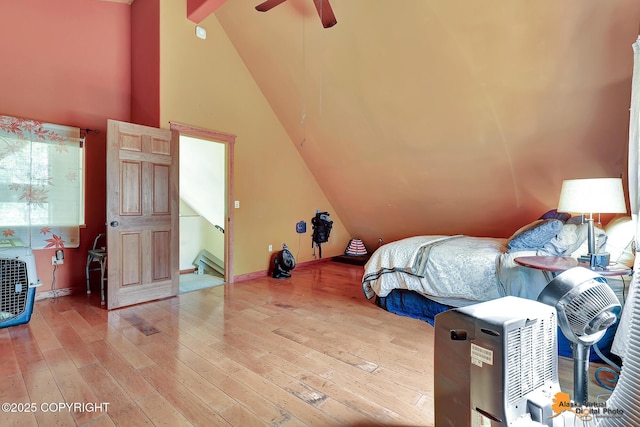 7408 N Grouse Loop, Wasilla, AK 99654 - unfurnished bedroom with vaulted ceiling, light wood-style flooring, and a ceiling fan