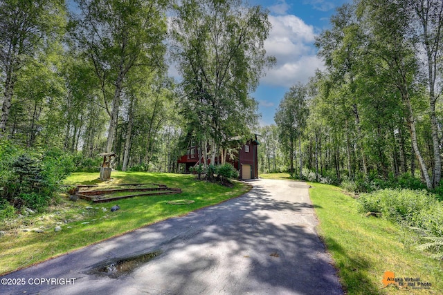 7408 N Grouse Loop, Wasilla, AK 99654 - view of asphalt driveway with a view of trees