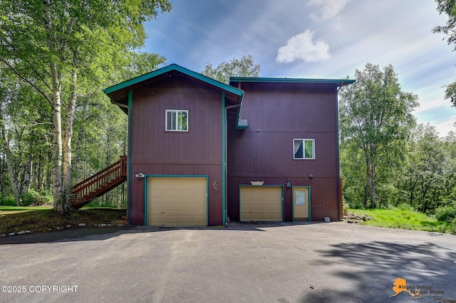 7408 N Grouse Loop, Wasilla, AK 99654 - view of front facade featuring an attached garage and asphalt driveway