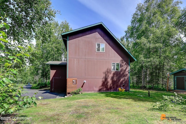 7408 N Grouse Loop, Wasilla, AK 99654 - view of side of property with a lawn and an outdoor structure