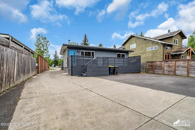1601 Bannister Dr, Anchorage, AK 99508 - rear view of property featuring driveway