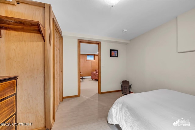 1601 Bannister Dr, Anchorage, AK 99508 - bedroom featuring baseboards, light wood-type flooring, and a baseboard radiator