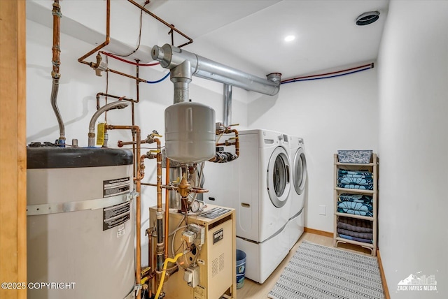 1601 Bannister Dr, Anchorage, AK 99508 - laundry area with secured water heater, separate washer and dryer, a heating unit, and wood finished floors