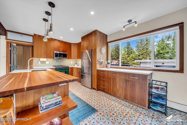 1601 Bannister Dr, Anchorage, AK 99508 - kitchen with stainless steel appliances, butcher block counters, a sink, decorative backsplash, and hanging light fixtures