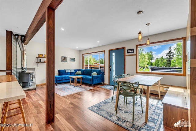 1601 Bannister Dr, Anchorage, AK 99508 - dining area featuring a wood stove, wood finished floors, and recessed lighting