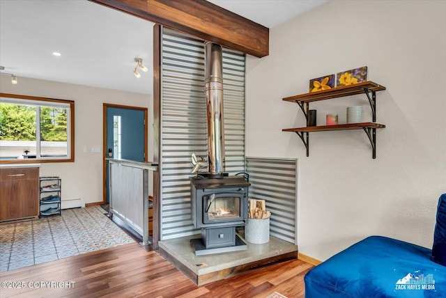 1601 Bannister Dr, Anchorage, AK 99508 - detailed view of a wood stove, baseboards, wood finished floors, recessed lighting, and a baseboard heating unit