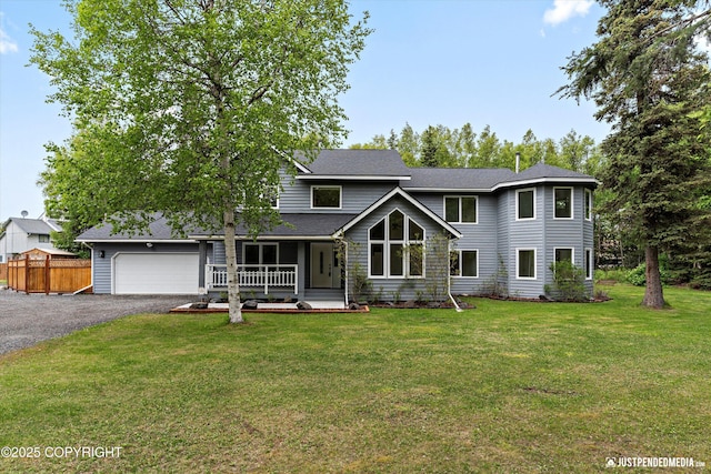 1701 Woo Blvd, Anchorage, AK 99515 - view of front of home with an attached garage, a porch, asphalt driveway, and roof with shingles