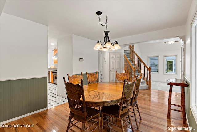 1701 Woo Blvd, Anchorage, AK 99515 - dining area featuring light wood-style flooring, stairway, and a chandelier