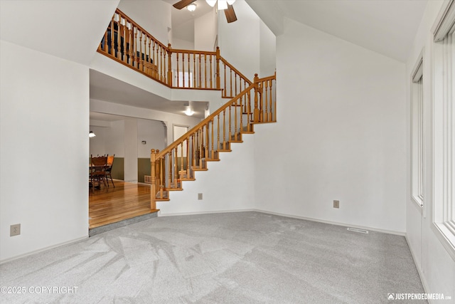 1701 Woo Blvd, Anchorage, AK 99515 - staircase featuring a ceiling fan, high vaulted ceiling, and carpet floors
