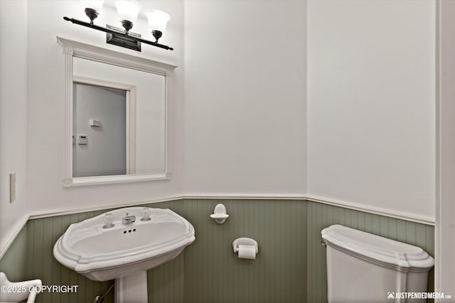 1701 Woo Blvd, Anchorage, AK 99515 - half bath featuring toilet, wainscoting, and a sink