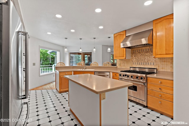 1701 Woo Blvd, Anchorage, AK 99515 - kitchen featuring high quality appliances, wall chimney exhaust hood, light floors, a peninsula, and light countertops