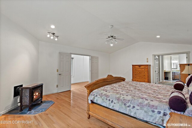 1701 Woo Blvd, Anchorage, AK 99515 - bedroom featuring a wood stove, vaulted ceiling, wood finished floors, recessed lighting, and ceiling fan