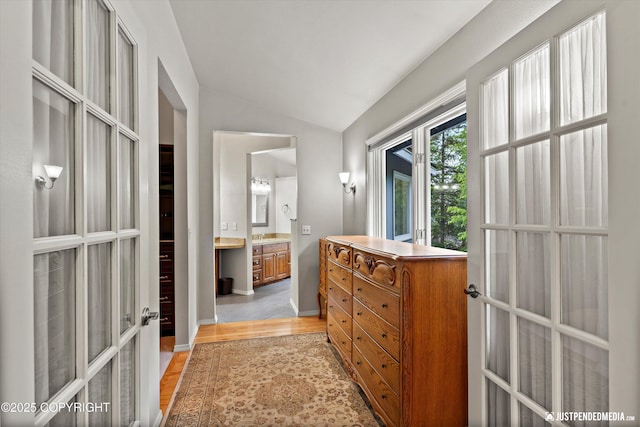 1701 Woo Blvd, Anchorage, AK 99515 - hall with light wood-style flooring, vaulted ceiling, and baseboards